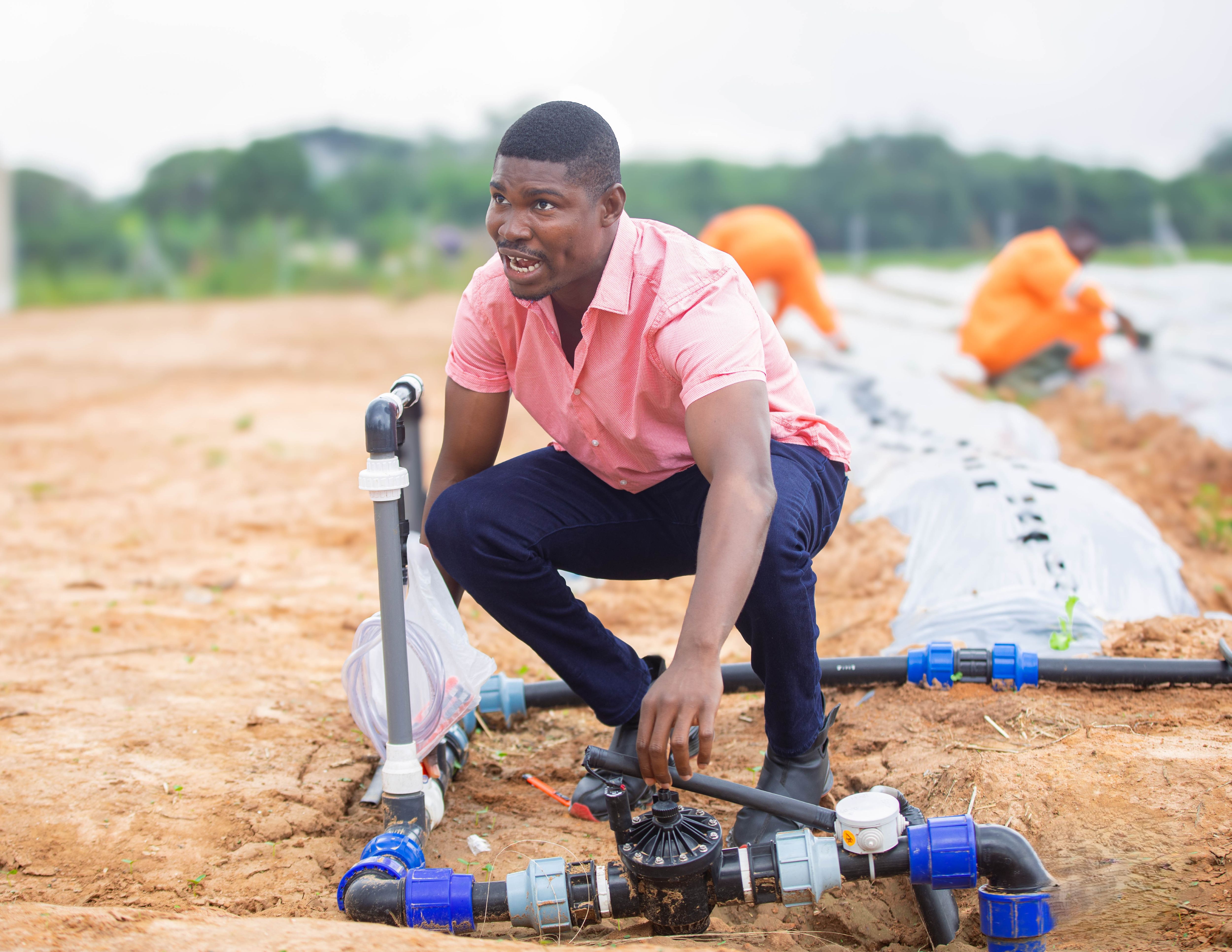 Alex Afari shedding light on the Irrigation System.